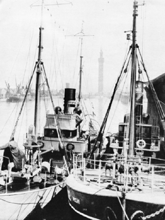 A naval trawler alongside a Grimsby fishing vessel