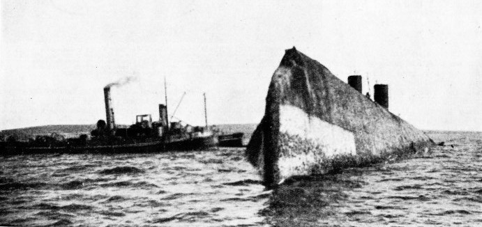 RAISED AFTER TEN YEARS on the sea-bed, the German battleship Kaiser in 1929