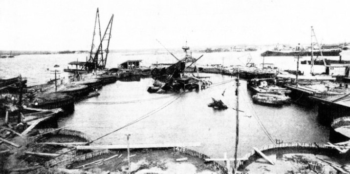 HUGE CYLINDERS formed the elliptical coffer-dam built round the wreck of the Maine