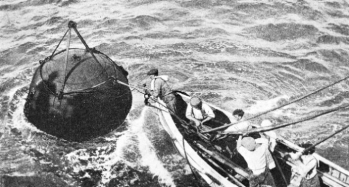 RECOVERING A MARK BUOY which is put down by a cable repair ship as soon as she reaches the position of a fault in the cable