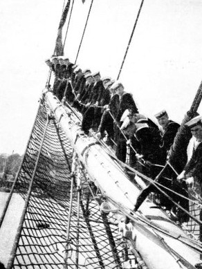 BOYS AT WORK on the bowsprit of the Arethusa