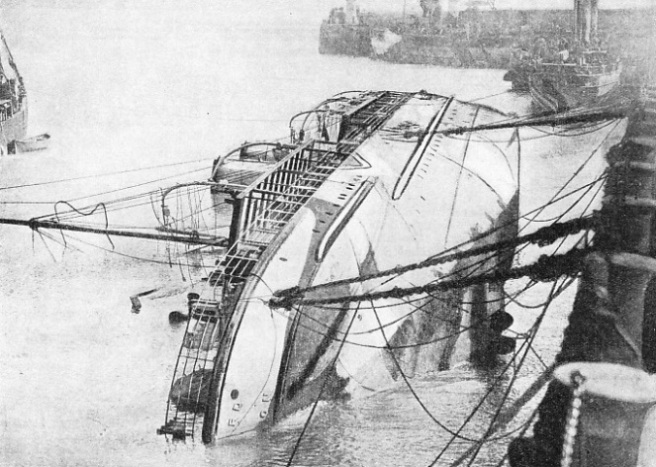 The troopship Onward lying on her side by the quay in Folkestone Harbour