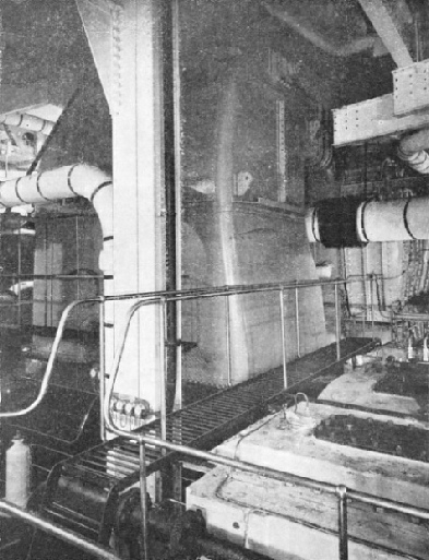 THE GIANT EXHAUST TRUNKING from one of the low-pressure turbines in the Queen Mary’s main engine-room