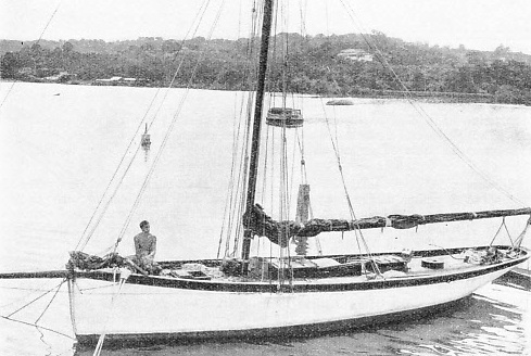 A photograph of Alain Gerbault sitting in the bow of the Firecrest