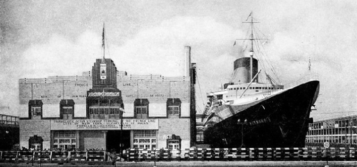 The Normandie dominate the scene at the entrance to Pier 38, New York